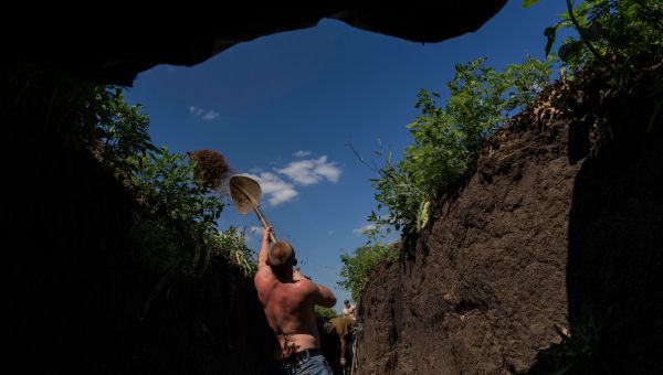 Ukrainian soldiers settle into trenches near the eastern front lines.