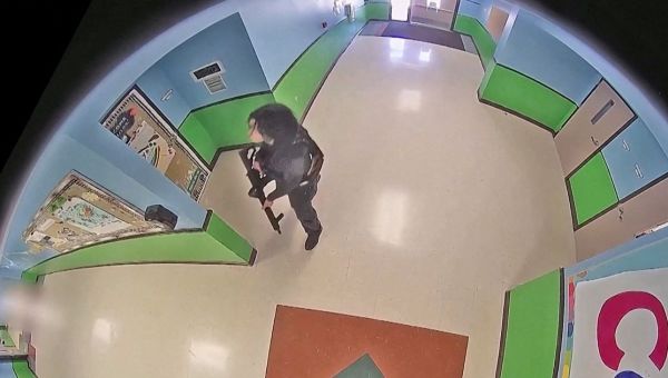 Gunman strolls into school with rifle in chilling new footage as 21 massacred