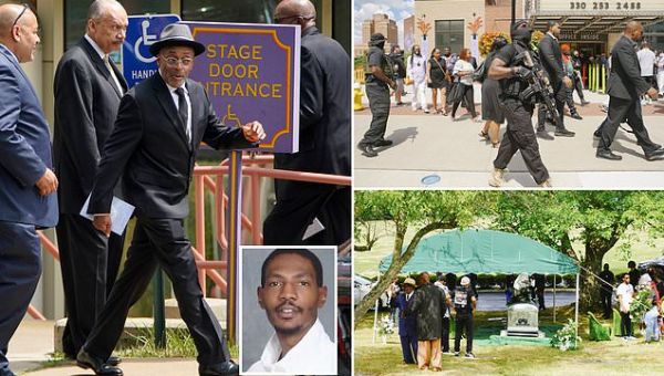 Protesters stand guard with rifles outside Jayland Walker’s funeral
