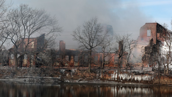 Demolition of fire ravaged Passaic warehouse underway. Crews monitoring wreckage.