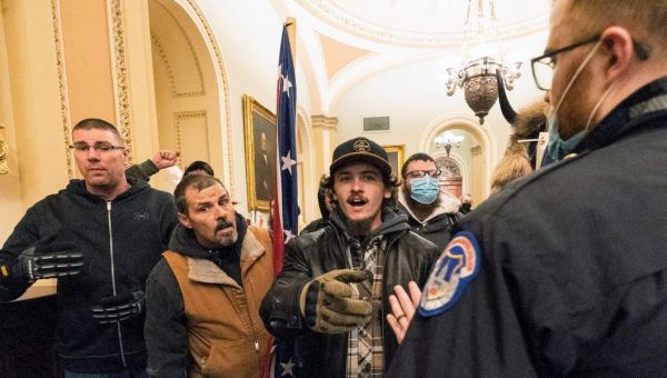 Man who carried a Confederate flag inside the US Capitol was the 'complete opposite of pleasant,' cop testifies