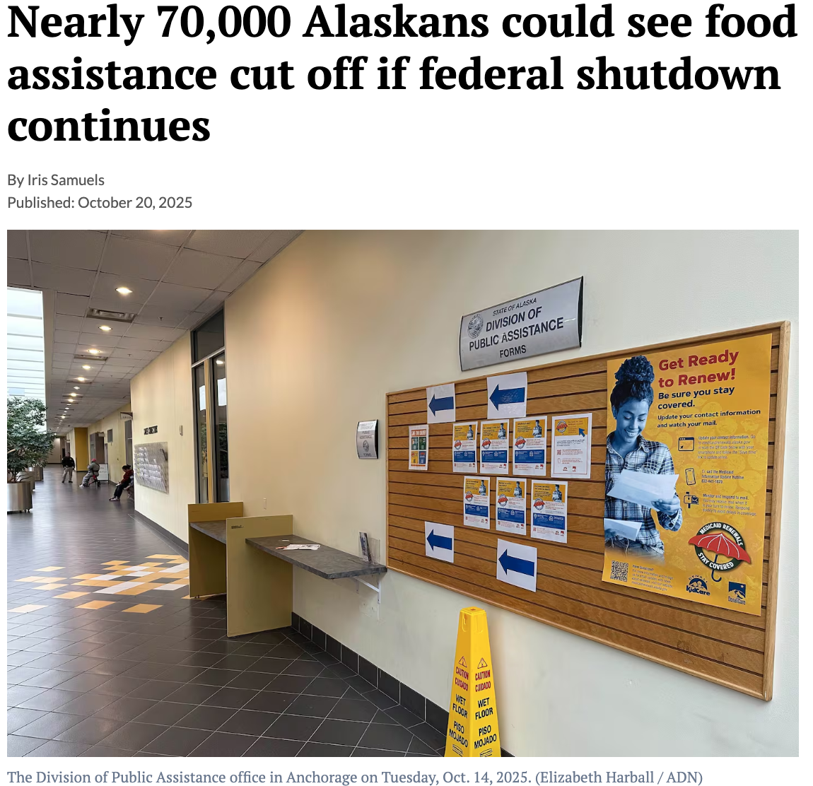 A hallway at the Division of Public Assistance office in Anchorage with a bulletin board displaying posters and forms, photographed on October 14, 2025.