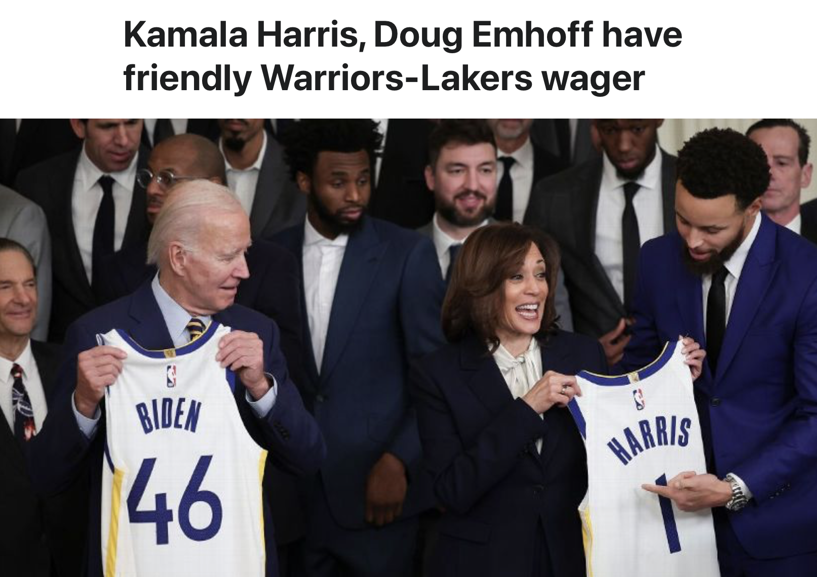President Joe Biden and Vice President Kamala Harris hold up Warriors basketball jerseys with their names during a group photo, surrounded by team members.