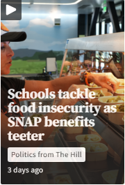 A cafeteria worker arranges food trays on a counter, with text overlay discussing schools addressing food insecurity amid uncertain SNAP benefits.