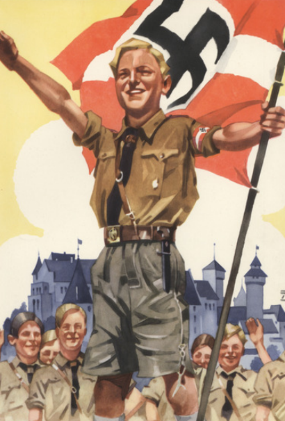 A group of boys in brown uniforms, one holding a flag with a swastika symbol, stand in front of a building with arched towers.