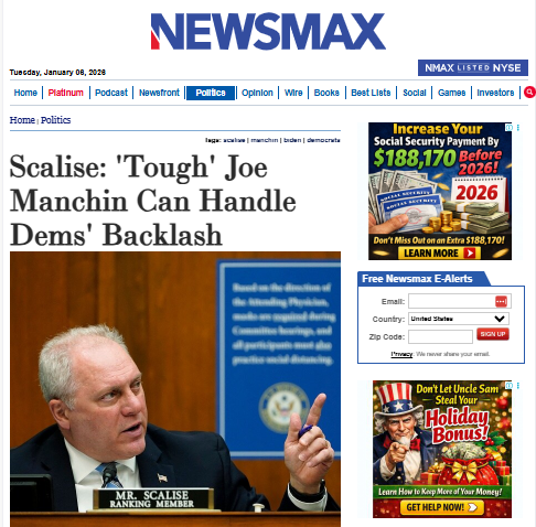 A man in a suit pointing up.