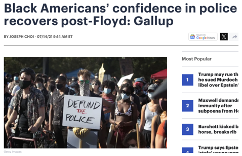 A group of people at a protest hold signs, including one that reads "DEFUND THE POLICE." Most are wearing masks and sunglasses.