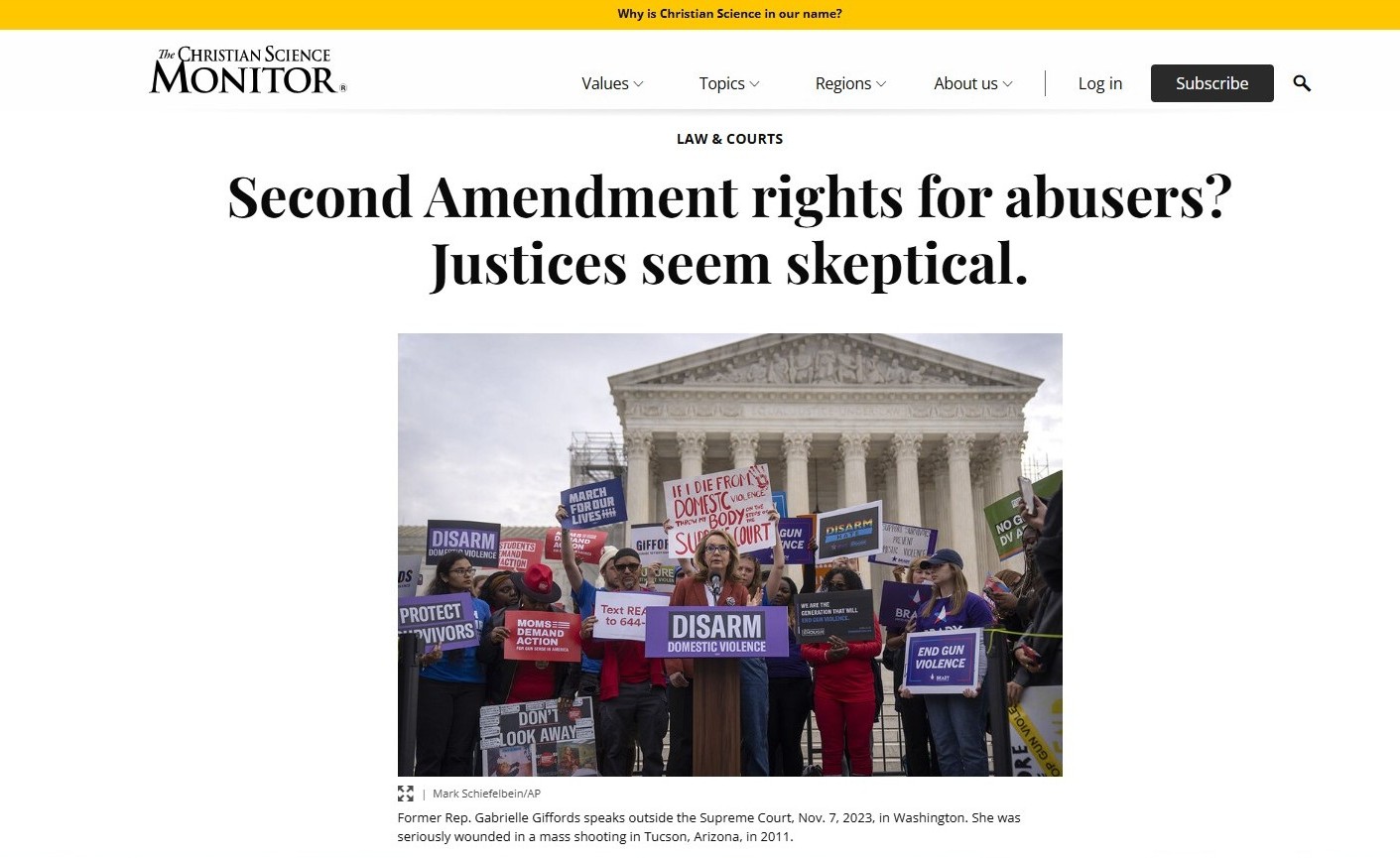 People holding signs about gun control in front of the U.S. Supreme Court building, with one speaker addressing the crowd.