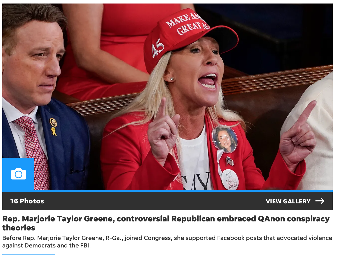 Marjorie Taylor Greene wearing a red "Make America Great Again" hat and speaking emphatically while seated among others in a crowded room.