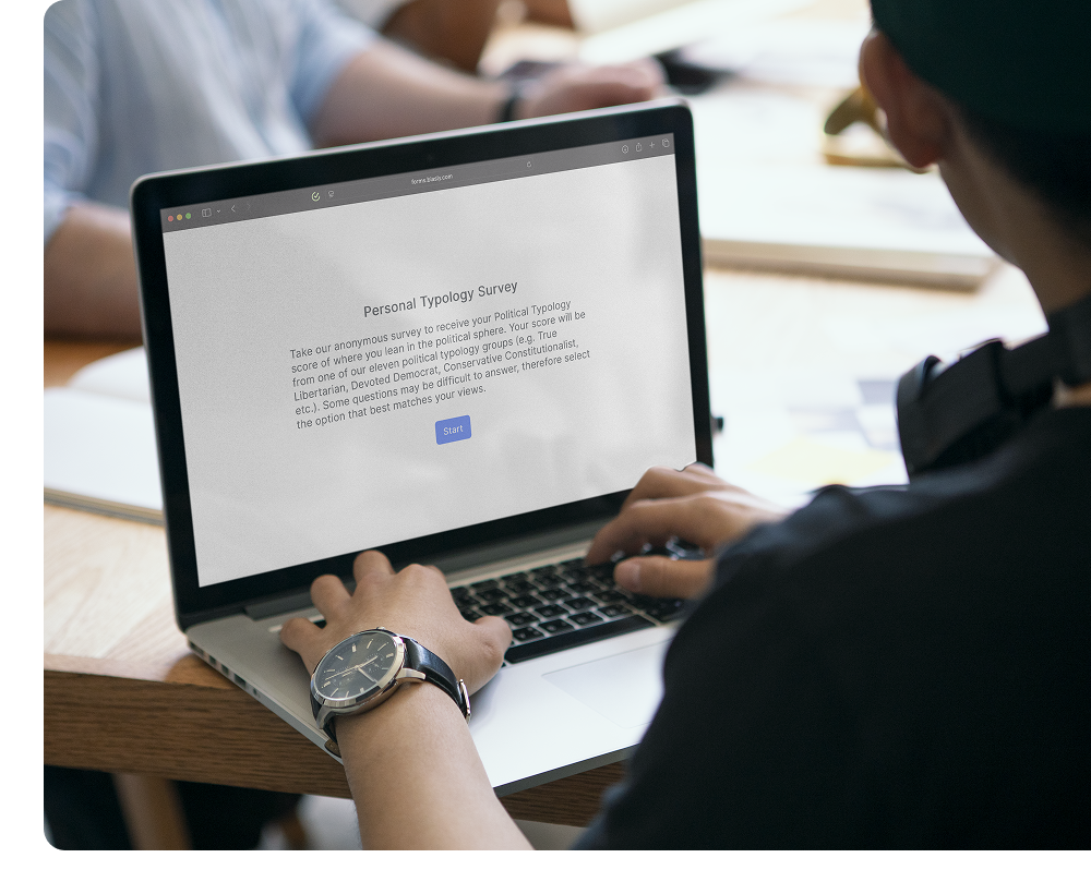 Person using a laptop to view a "Personal Typology Survey" webpage, with hands on the keyboard and text and a blue "Start" button displayed on the screen.