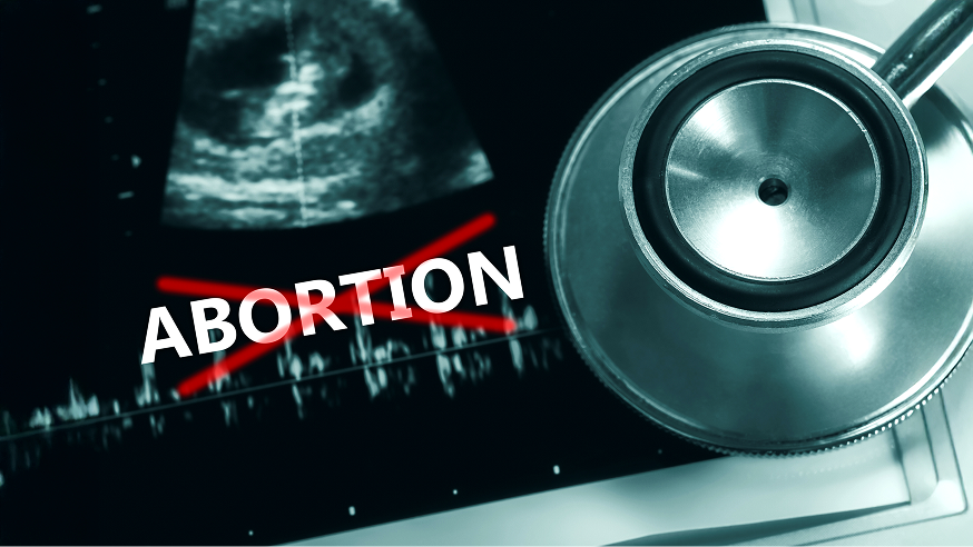 An ultrasound image and a stethoscope are shown with the word "Abortion" crossed out in red.